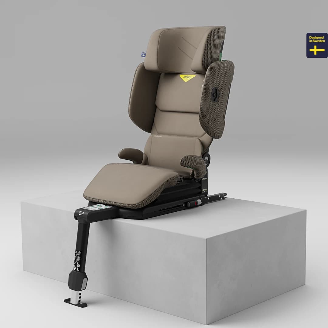 Axkid Up high-back booster seat on a studio plinth