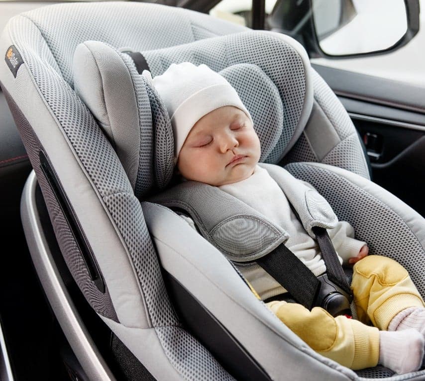 A baby supported in a rear-facing BeSafe seat