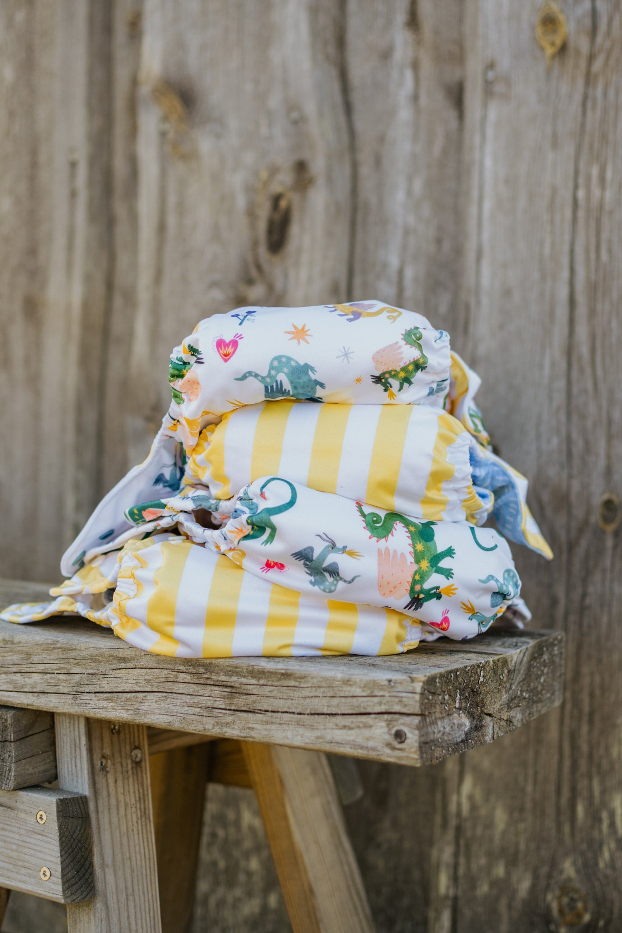 A colourful stack of Little Lovebum reusable nappies