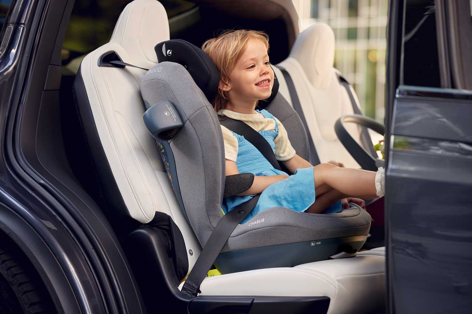 Child sitting in a Swandoo Charlie booster seat