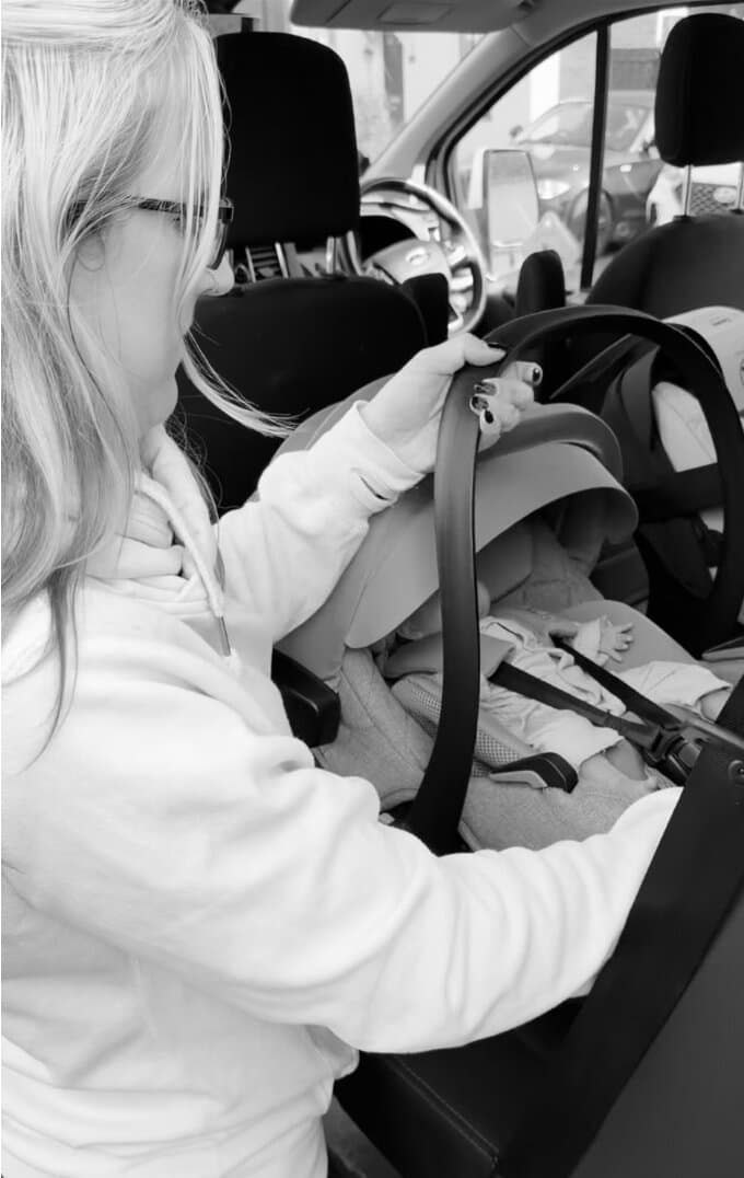 Charlene, founder of Saunders & Smalls, checking a car seat belt installation