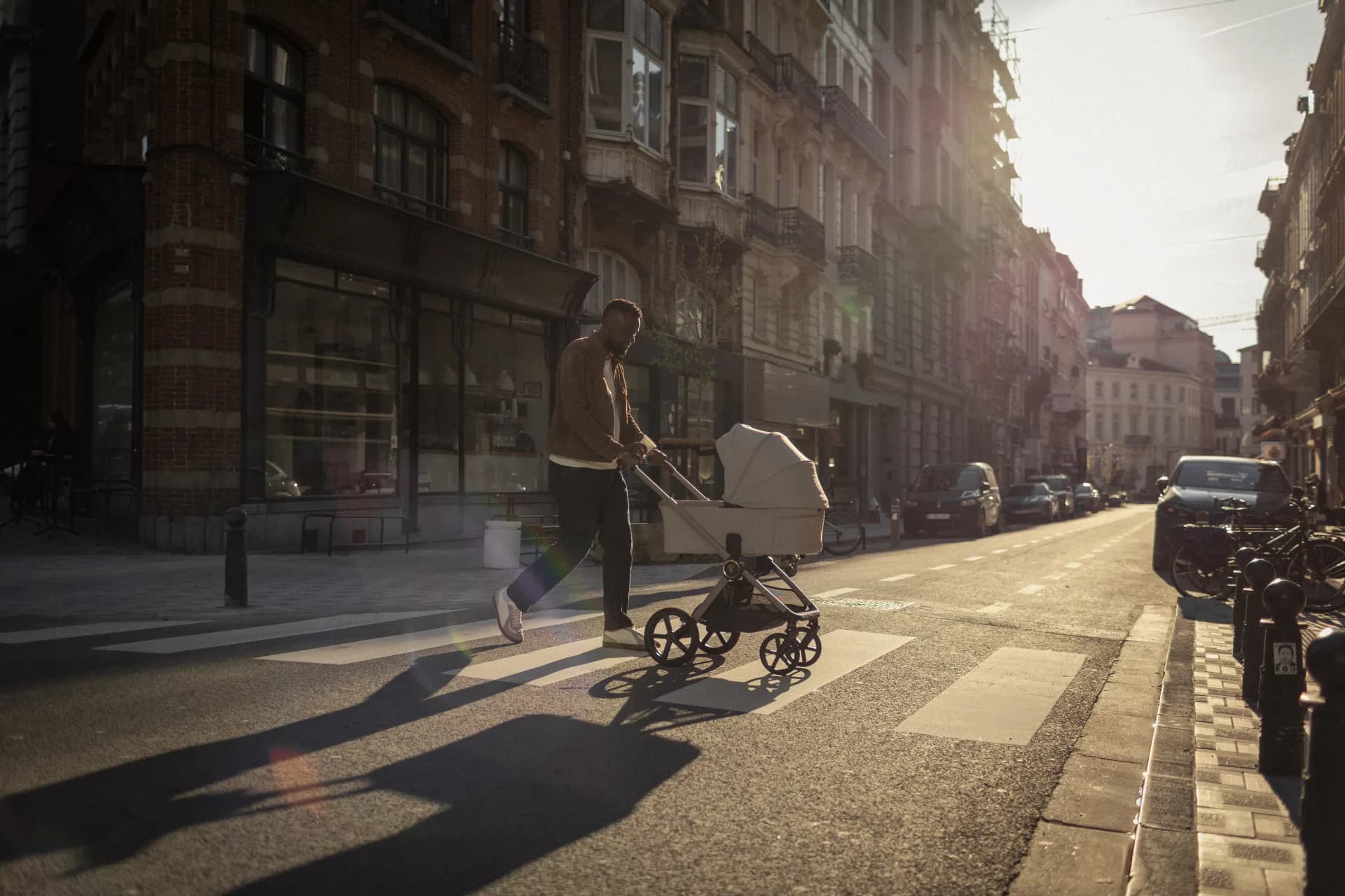 A parent walking through the city with a Venicci Upline 3 pushchair